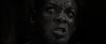 Movie still from “Emancipation” (2022), directed by Antoine Fuqua – A man's face in black and white; Extreme Close Up shot, Low angle