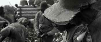 Movie still from “Emancipation” (2022), directed by Antoine Fuqua – A woman wearing a hat is standing next to a man; Close Up shot, High angle
