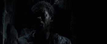 Movie still from “Emancipation” (2022), directed by Antoine Fuqua – A man is smoking a cigarette in the dark; Close Up shot, High angle