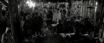 Movie still from “Emancipation” (2022), directed by Antoine Fuqua – A group of people standing around a room; Wide shot, High angle