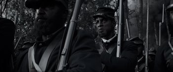 Movie still from “Emancipation” (2022), directed by Antoine Fuqua – A black and white photo of a man in a uniform; Close Up shot, Low angle