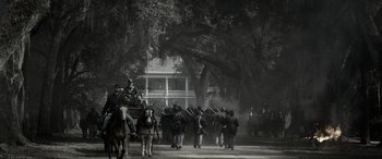 Movie still from “Emancipation” (2022), directed by Antoine Fuqua – A black and white photo of a civil war reenactment; Extreme Wide shot, Low angle