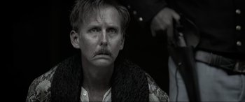 Movie still from “Emancipation” (2022), directed by Antoine Fuqua – A black and white photo of a man with a mustache; Close Up shot, Over the shoulder angle