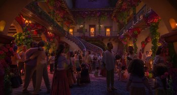 Movie still from “Encanto” (2021), directed by Charise Castro Smith – A group of people standing in a courtyard at night; Extreme Wide shot, Over the shoulder angle