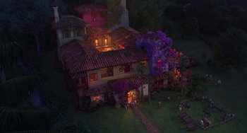 Movie still from “Encanto” (2021), directed by Charise Castro Smith – An aerial view of a house at night with purple flowers; Extreme Wide shot, Overhead angle