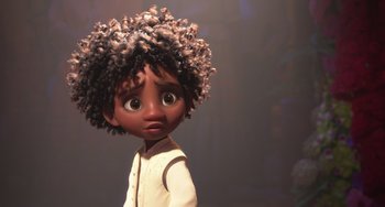 Movie still from “Encanto” (2021), directed by Charise Castro Smith – A cartoon of a young girl with a curly hair style; Close Up shot, Low angle