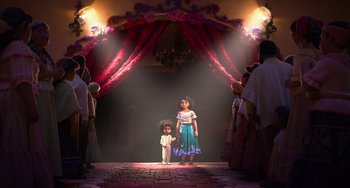 Movie still from “Encanto” (2021), directed by Charise Castro Smith – Two little girls standing in front of an audience; Wide shot, Low angle