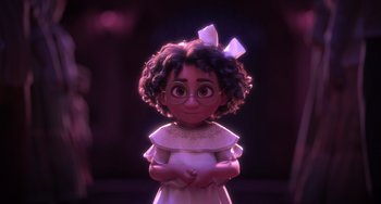 Movie still from “Encanto” (2021), directed by Charise Castro Smith – A girl with curly hair wearing a white dress; Medium shot, Over the shoulder angle