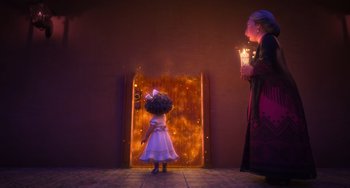 Movie still from “Encanto” (2021), directed by Charise Castro Smith – A little girl standing in front of an open door; Wide shot, Over the shoulder angle