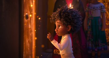 Movie still from “Encanto” (2021), directed by Charise Castro Smith – A little girl is standing in front of a window; Medium shot, Over the shoulder angle