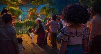 Movie still from “Encanto” (2021), directed by Charise Castro Smith – A group of people standing in front of a forest; Wide shot, Over the shoulder angle
