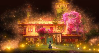 Movie still from “Encanto” (2021), directed by Charise Castro Smith – A girl standing in front of a house at night; Extreme Wide shot, Low angle