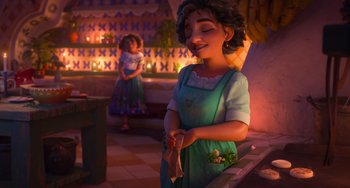 Movie still from “Encanto” (2021), directed by Charise Castro Smith – A woman standing in front of a counter; Medium shot, Over the shoulder angle