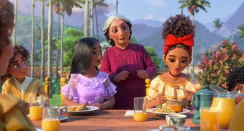 Movie still from “Encanto” (2021), directed by Charise Castro Smith – A group of people sitting at a table eating food; Medium shot, Over the shoulder angle