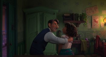 Movie still from “Encanto” (2021), directed by Charise Castro Smith – A man and a woman are hugging in a green room; Medium shot, Over the shoulder angle