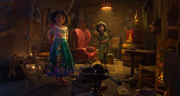 Movie still from “Encanto” (2021), directed by Charise Castro Smith – Two girls in a room with a fireplace and chairs; Wide shot, Over the shoulder angle