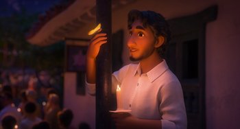 Movie still from “Encanto” (2021), directed by Charise Castro Smith – A statue of a man holding a lit candle; Close Up shot, Over the shoulder angle