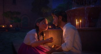 Movie still from “Encanto” (2021), directed by Charise Castro Smith – A man and a woman sitting next to each other in front of candles; Medium shot, Over the shoulder angle