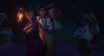 Movie still from “Encanto” (2021), directed by Charise Castro Smith – A man and a woman standing next to each other in the dark; Medium shot, Low angle