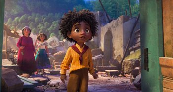 Movie still from “Encanto” (2021), directed by Charise Castro Smith – A little girl standing in front of a stone wall; Wide shot, Low angle