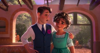 Movie still from “Encanto” (2021), directed by Charise Castro Smith – A man and a woman standing next to each other; Medium shot, Over the shoulder angle