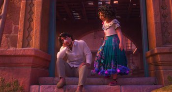Movie still from “Encanto” (2021), directed by Charise Castro Smith – A man and a little girl sitting on some steps; Wide shot, Over the shoulder angle