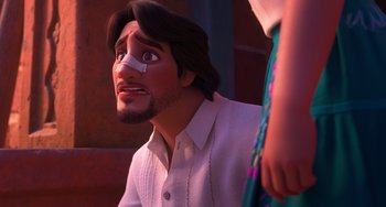 Movie still from “Encanto” (2021), directed by Charise Castro Smith – A man with bandages on his face looking up at something; Close Up shot, Over the shoulder angle