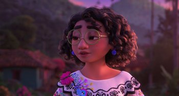 Movie still from “Encanto” (2021), directed by Charise Castro Smith – A woman with a flower in her hair wearing glasses; Close Up shot, Over the shoulder angle