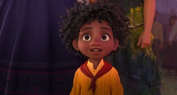 Movie still from “Encanto” (2021), directed by Charise Castro Smith – A young black boy with curly black hair; Close Up shot, Low angle