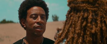 Movie still from “End of the Road” (2022), directed by Millicent Shelton – A person talking to another person; Close Up shot, Over the shoulder angle