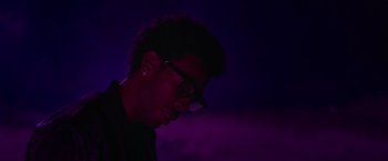 Movie still from “End of the Road” (2022), directed by Millicent Shelton – A man with glasses is looking down at the ground; Close Up shot, Low angle