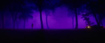 Movie still from “End of the Road” (2022), directed by Millicent Shelton – A person standing in the middle of a field at night; Extreme Wide shot, Low angle