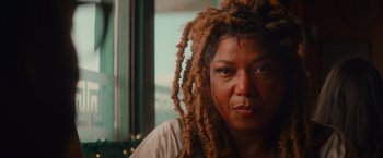 Movie still from “End of the Road” (2022), directed by Millicent Shelton – A person with dreadlocks; Close Up shot, Low angle