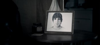 A black and white photo of a young man in a frame
