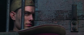Movie still from “Enemy at the Gates” (2001), directed by Jean-Jacques Annaud – A person wearing a hat; Close Up shot, Low angle