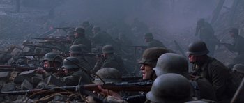 Movie still from “Enemy at the Gates” (2001), directed by Jean-Jacques Annaud – A large group of soldiers are gathered in a field; Medium shot, Low angle