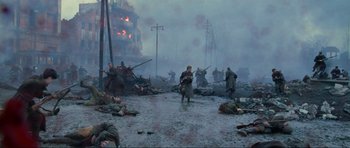 Movie still from “Enemy at the Gates” (2001), directed by Jean-Jacques Annaud – A group of men in the middle of a field; Wide shot, High angle