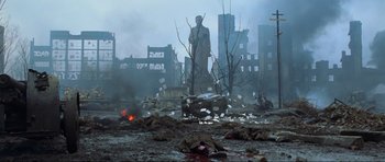 Movie still from “Enemy at the Gates” (2001), directed by Jean-Jacques Annaud – A statue in the middle of a destroyed city; Extreme Wide shot, High angle