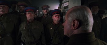 Movie still from “Enemy at the Gates” (2001), directed by Jean-Jacques Annaud – A group of men in military uniforms standing next to each other; Medium shot, Low angle