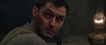 Movie still from “Enemy at the Gates” (2001), directed by Jean-Jacques Annaud – A man's face as he stares into the camera; Close Up shot, Over the shoulder angle