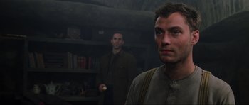 Movie still from “Enemy at the Gates” (2001), directed by Jean-Jacques Annaud – Two men standing next to each other in a dark room; Close Up shot, Low angle