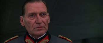 Movie still from “Enemy at the Gates” (2001), directed by Jean-Jacques Annaud – A person wearing a military uniform; Close Up shot, Low angle