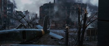 Movie still from “Enemy at the Gates” (2001), directed by Jean-Jacques Annaud – An old plane sitting in the middle of a destroyed city; Extreme Wide shot, High angle