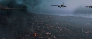 Movie still from “Enemy at the Gates” (2001), directed by Jean-Jacques Annaud – An aerial view of an airplane flying over a city; Extreme Wide shot, High angle