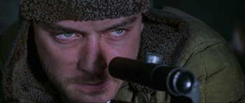 Movie still from “Enemy at the Gates” (2001), directed by Jean-Jacques Annaud – A person looking through a telescope; Extreme Close Up shot, Low angle