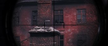 Movie still from “Enemy at the Gates” (2001), directed by Jean-Jacques Annaud – A brick building with a brick wall and a brick chimney; Extreme Wide shot, Overhead angle
