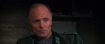 Movie still from “Enemy at the Gates” (2001), directed by Jean-Jacques Annaud – A person wearing a uniform; Close Up shot, Low angle