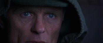 Movie still from “Enemy at the Gates” (2001), directed by Jean-Jacques Annaud – A person's eyes with a hat on; Extreme Close Up shot, Overhead angle