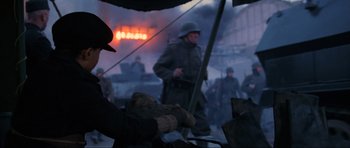 Movie still from “Enemy at the Gates” (2001), directed by Jean-Jacques Annaud – An image of a man in the middle of a war scene; Medium shot, Over the shoulder angle