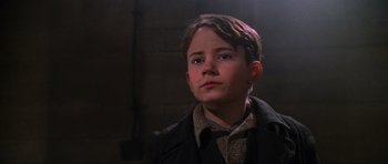 Movie still from “Enemy at the Gates” (2001), directed by Jean-Jacques Annaud – A young boy wearing a jacket and a tie; Close Up shot, Low angle